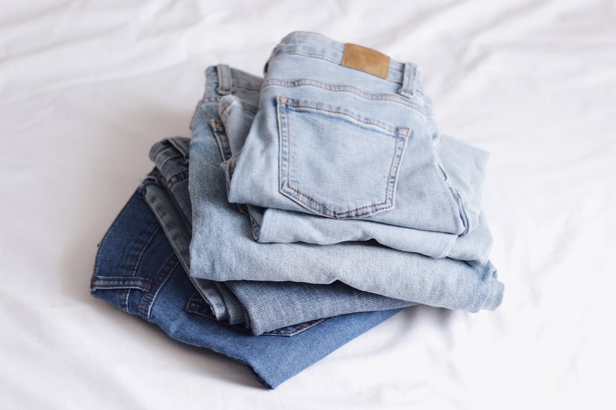 stack of light and mid-washed denim jeans